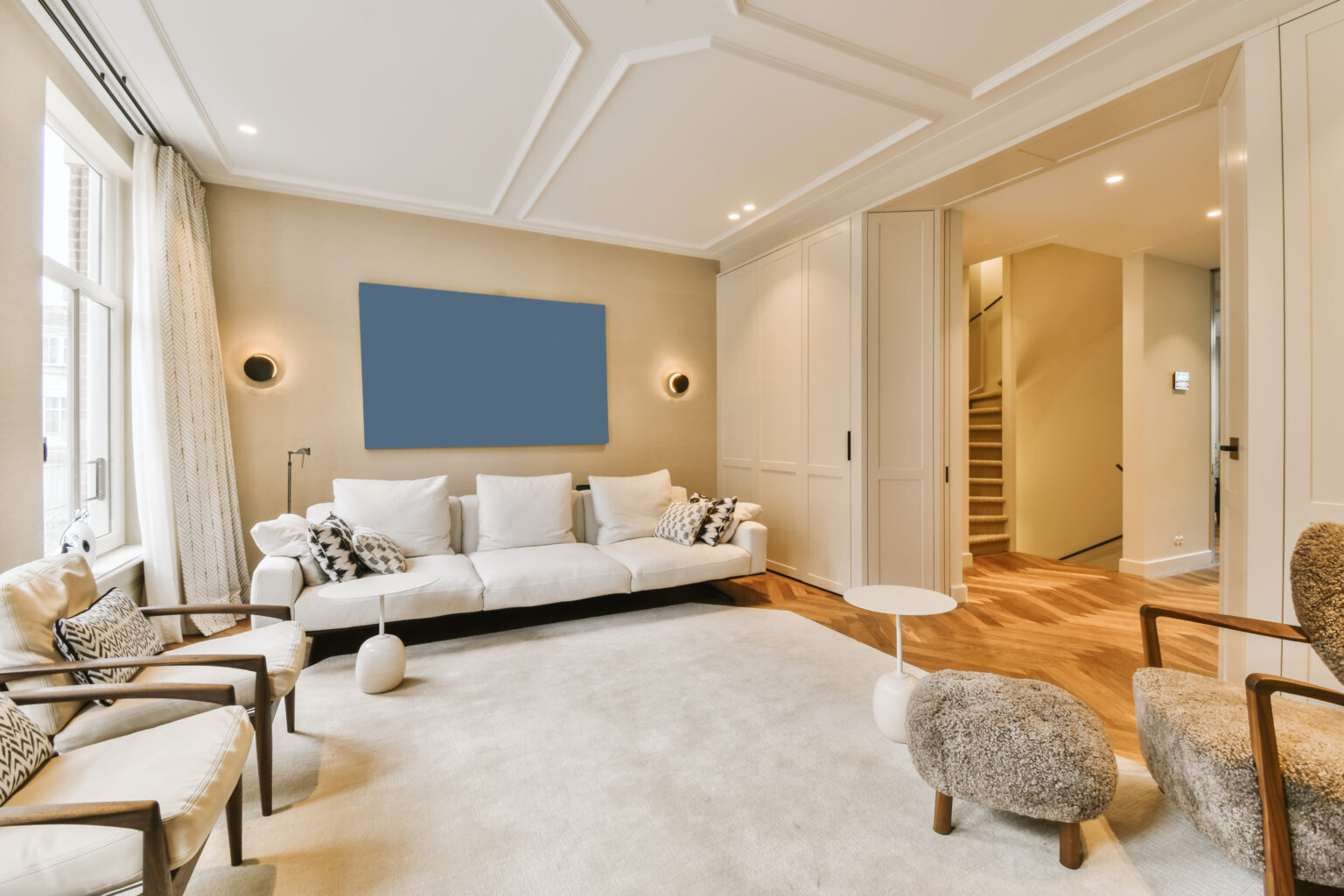 a living room with couches, chairs and a large mirror on the wall in the room is very clean