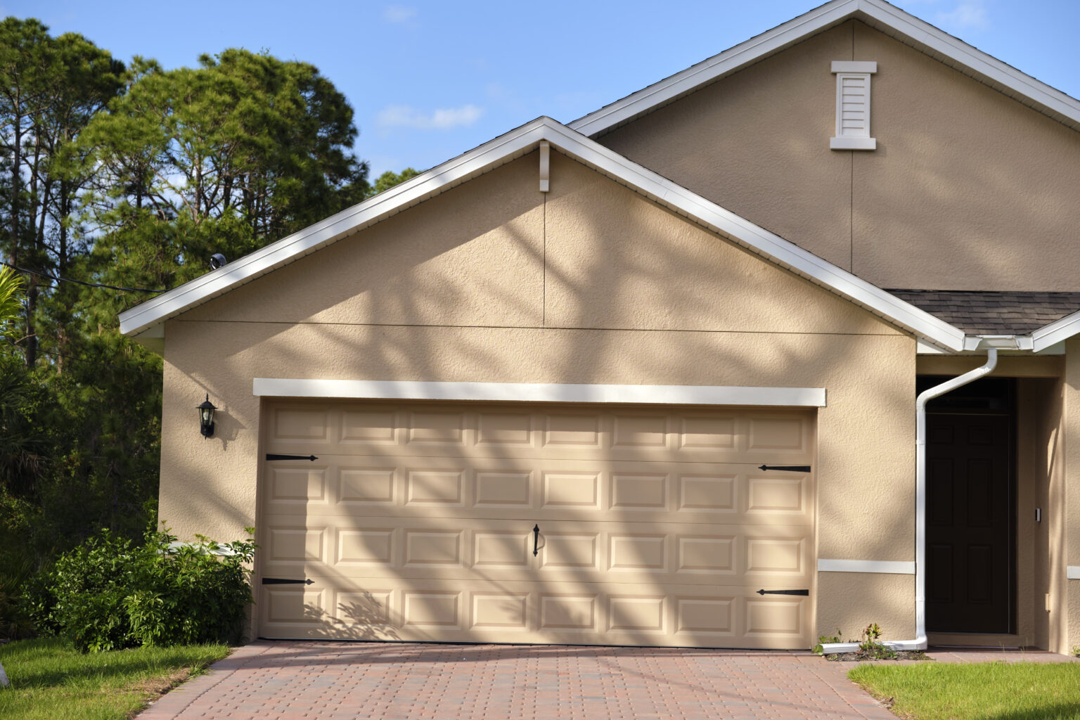 Wide garage double door and concrete driveway of new modern american house.